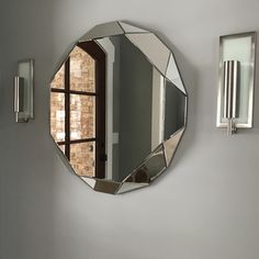 a mirror hanging on the wall above a sink