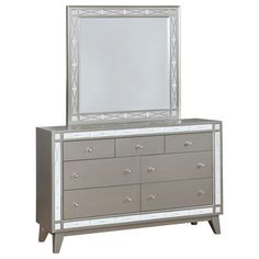 a dresser with a mirror on top of it and drawers in front of the mirror