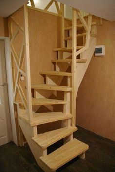 a wooden stair case in a home with wood flooring