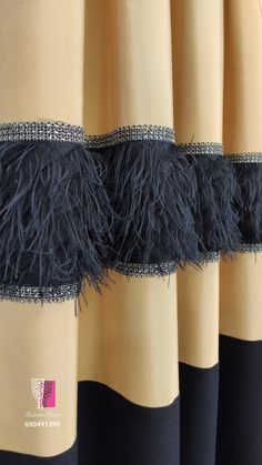 black and yellow curtains with fringes on them