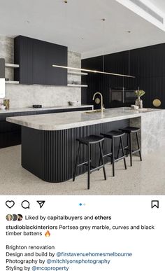 an image of a kitchen with black cabinets and marble counter tops on instagrams