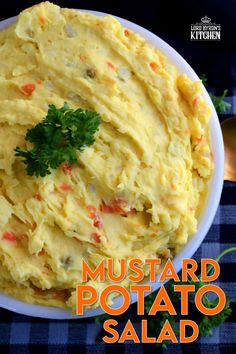 a bowl filled with mashed potato salad on top of a blue checkered table cloth