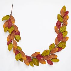 a necklace made out of leaves on a white background