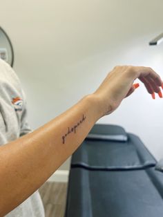 a woman's arm with a tattoo that reads, hope on it and the word faith written in cursive font