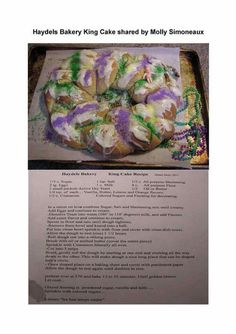 a cake with purple and green icing on it is in a box next to a recipe sheet