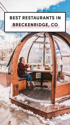 a woman sitting at a table in a glass dome with the words best restaurants in breckenridge, co