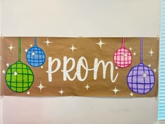 a sign that says prom hanging from the side of a wall in front of a window