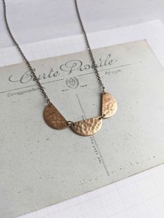 This simple necklace has three half moons in beaten brass to make a scalloped row. Placed on fine bronze chain. Each semi-circle 3/4" wide.  Necklace measures 17" long in total.  Nickel free. Each piece comes beautifully wrapped.  Made in Manchester, UK. Join me on instagram: https://www.instagram.com/themagpiesdaughter Style Inspiration Work, Wide Necklace, Half Moons, Dot Necklace, Minimalist Jewellery, Brass Texture, Gold Moon, Brass Necklace, Beading Ideas