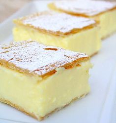 two pieces of cake on a plate with powdered sugar and icing over them