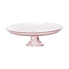 a pink glass cake plate on a white background