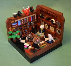 a lego model of a living room with furniture and decorations on the walls, including bookshelves