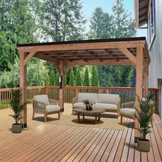 a wooden deck with furniture and plants on it