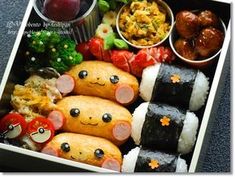 a bento box filled with sushi and vegetables