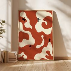 an orange and white camouflage print is on the wall in front of a bookshelf