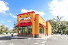 a large yellow building with a red awning