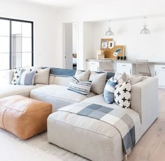 a living room filled with furniture next to a sliding glass door and wooden flooring