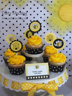 cupcakes with yellow frosting are on a cake stand