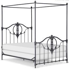 an iron bed frame with four posts and white linens on the bottom, is shown