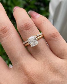 a woman's hand with a ring on it and a diamond in the middle