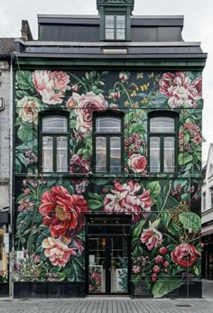 an old building with flowers painted on it