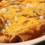 a casserole dish with cheese and onions on it is ready to be eaten