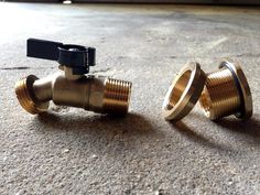 two brass valves sitting on the ground next to each other