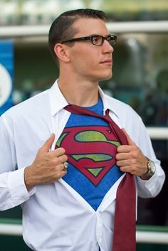 a man wearing a superman shirt and tie