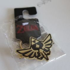 a zelda pin sitting on top of a plastic bag