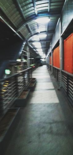 an empty subway station with orange doors