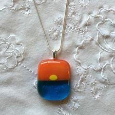 "Fused Glass Sunset Necklace with Turquoise blue water, yellow bright sun and orange sunset skies... Please note that all my items are Handmade so there may be slight color and / or design variations. The pendant is mounted on a sterling silver plated leaf bail. It comes on a 16\" OR 18\" silver plated snake chain necklace OR black leather cord (finished with silver plated lobster clasp and 2\" chain for adjustable length). Please choose your options upon checkout. Your pendant arrives in a gift Fused Glass Sunset, Sunset Necklace, Fused Glass Pendant Necklace, Sunset Skies, Wave Jewelry, Jewelry Ocean, Fused Glass Necklace, Fused Glass Earrings, Fused Glass Artwork