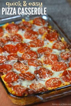 a pizza casserole with cheese and tomatoes on it in a glass baking dish