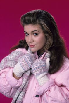 a woman in pink jacket and white gloves