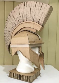 a helmet made out of cardboard sitting on top of a table