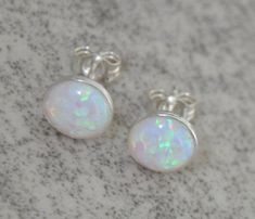 Shop Opal Stud Earrings, White Opal Earrings Sterling Silver , 8mm Opal, Bridesmaid Gift, Bridal Opal Jewelry, Gift For Her I made these white opal earrings with: - Gorgeous multicolored lab created round opal cabochons-8 mm - Solid 925 sterling silver bezels with a post You'll get sterling silver stoppers and silicone backs. Created opals are actually preferred to natural opals for many jewelry items. Natural opal is not particularly well-suited to being used in many jewelry applications since Cute Opal Earrings, Luxury White Opal Jewelry, Bridal Earrings Opal, Silver Opal Jewelry, Wedding Cyprus, White Opal Earrings, Opal Stud Earrings, Opal Earrings Stud, Opal Studs