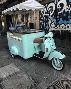 an ice cream cart is parked on the sidewalk