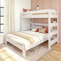 a white bunk bed sitting on top of a hard wood floor next to a window