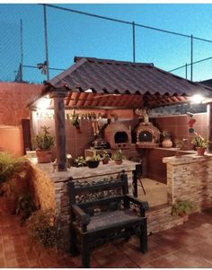 an outdoor kitchen is lit up at night