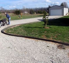 a man walking his dog down a gravel path