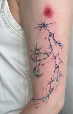 a woman's arm with a tattoo on it that has red and blue ink