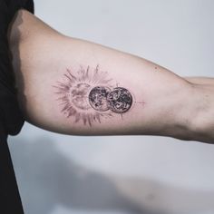 a man with a tattoo on his arm that has the sun and moon in it