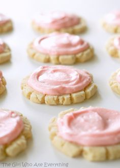 cookies with pink frosting on them sitting on top of a white countertop next to an instagram page