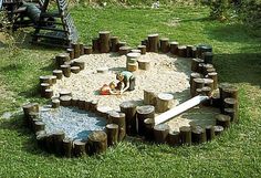 a child playing in a sandbox made out of logs