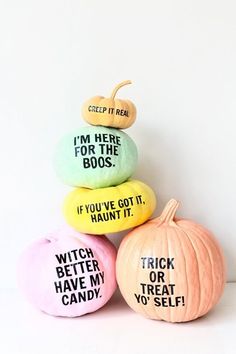 three pumpkins with words on them sitting next to each other