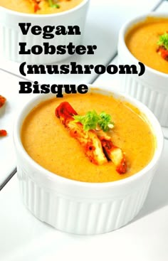 three white bowls filled with soup on top of a table