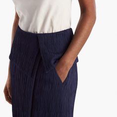 Sizing tip: This skirt runs large. Our stylists recommend ordering one size down. Inspired by classic tuxedo details, this sophisticated skirt features an angular, folded waist detail that creates a peplum-like silhouette. This season, we’ve updated it in a luxurious Italian knit with a pleated texture that allows for shaping and contouring in all the right places. Besom pockets add a little shine, while a secure underlayer keeps you feeling secured and well-covered. Elegant Formal Pleated Draped Skirt, Chic Asymmetrical Draped Skirt For Work, Elegant Fitted Draped Skirt With Folds, Modern Fitted Asymmetrical Skirt, Elegant Evening Pleated Draped Skirt, Summer Evening Bottoms With Pleated Waist, Formal Fitted Midi Draped Skirt, Formal Fitted Draped Midi Skirt, Elegant Draped Flowy Skirt With Folds