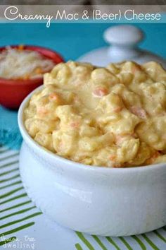 a white bowl filled with macaroni and cheese on top of a blue table cloth