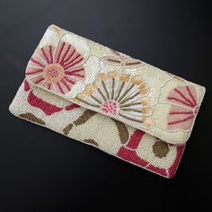 Hi ladies, this beautiful clutch bag will make you fall in love with the colors and design.  Carry with your matching dresses and wait for a million compliments. A beautiful shade of pink and pearl white adds to the whole look and the craftsmanship is topnotch.   Clutches come with detachable string, which you can add if you like and it is amazing without it too.  The size of this clutch is 9x6inch and the rear size is a comfortable cotton fabric so that it is easy to carry it with your dresses. This can be an amazing gift this Thanksgiving, Christmas, and New Year.  A gift wrap option is also available and we will love to pack it for your loved ones! For the first time, we are adding an amazing collection of clutches to our store, all handmade with love in India. Feminine Pink Clutch Evening Bag, Pink Rectangular Feminine Clutch, Elegant Spring Gift Clutch, Pink Clutch Evening Bag, Pink Pouch Evening Bag For Events, Feminine Pink Evening Bag For Events, Pink Rectangular Clutch For Spring, Pink Rectangular Clutch For Events, Elegant Pink Clutch As Gift