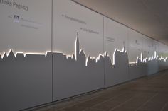 an image of a city skyline projected on a wall in a building with white lights