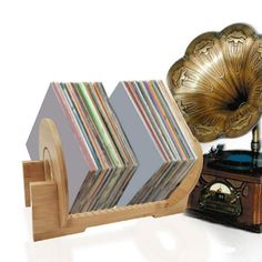 an old fashioned record player and wooden stand with various records on it's sides