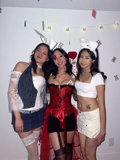 three women dressed in costumes posing for the camera